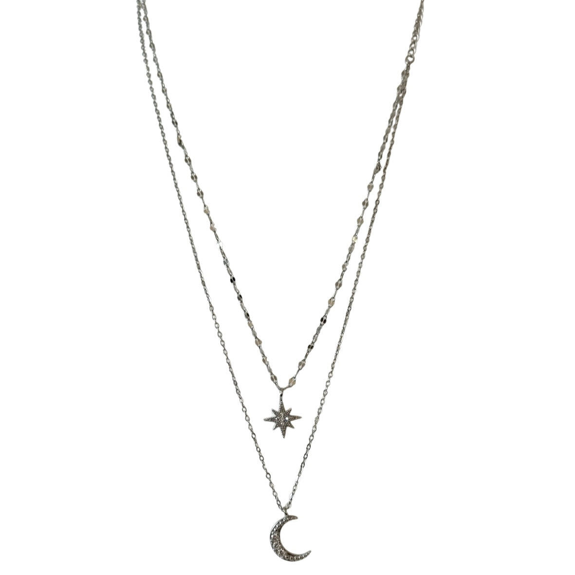 Layered necklace with star and moon pendants on a white background