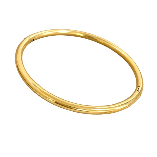 Gold bangle on a white background