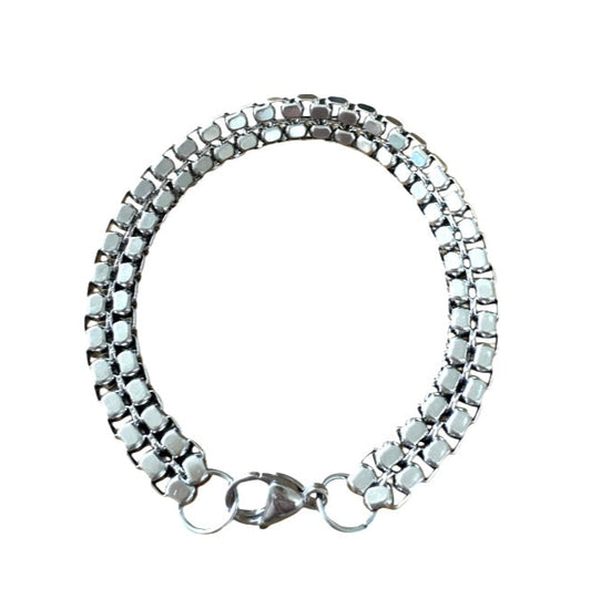 Silver bracelet with a clasp on a white background